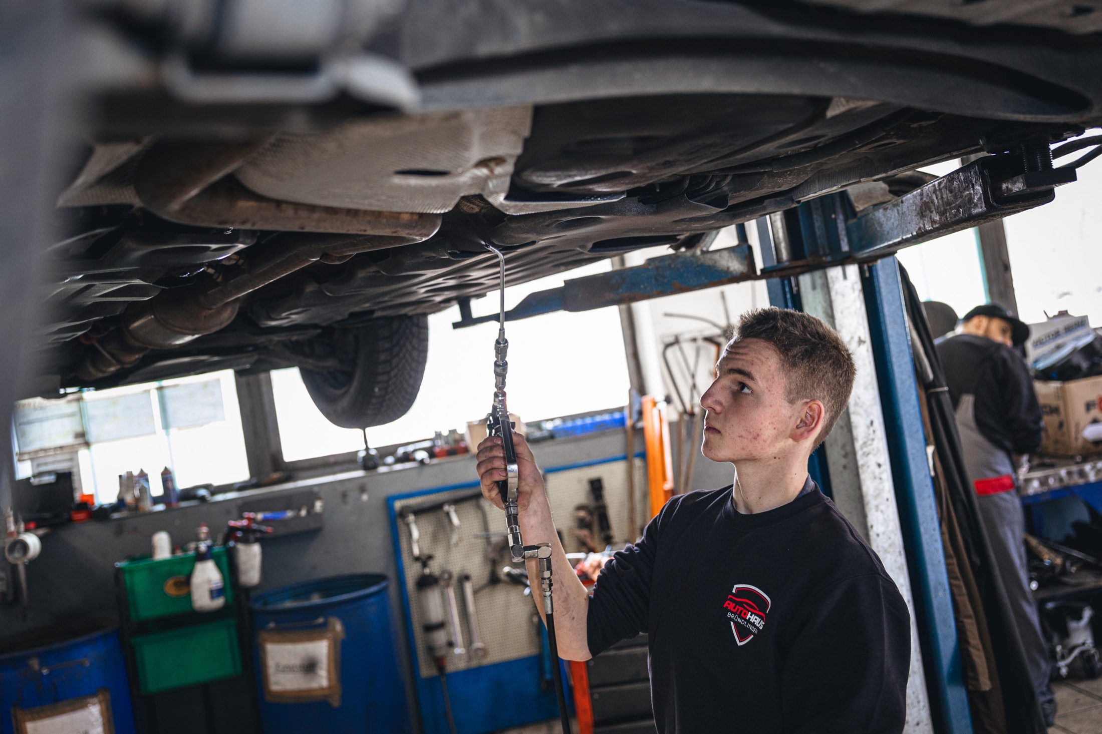 Kontrollarbeit unter dem Fahrzeug auf der Hebebühne
